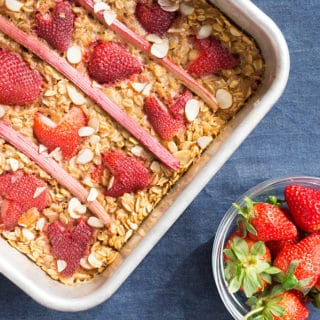 Strawberry Rhubarb Baked Oatmeal overhead with strawberries in rows on the top of baked oatmeal.