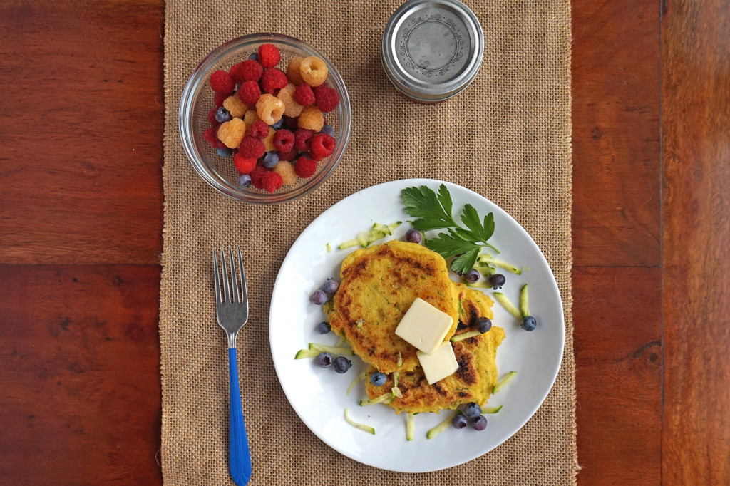 Zucchini Cornmeal Griddle Cakes overhead with bowl of raspberries