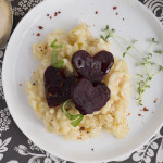 three heart shaped beets on top of risotto