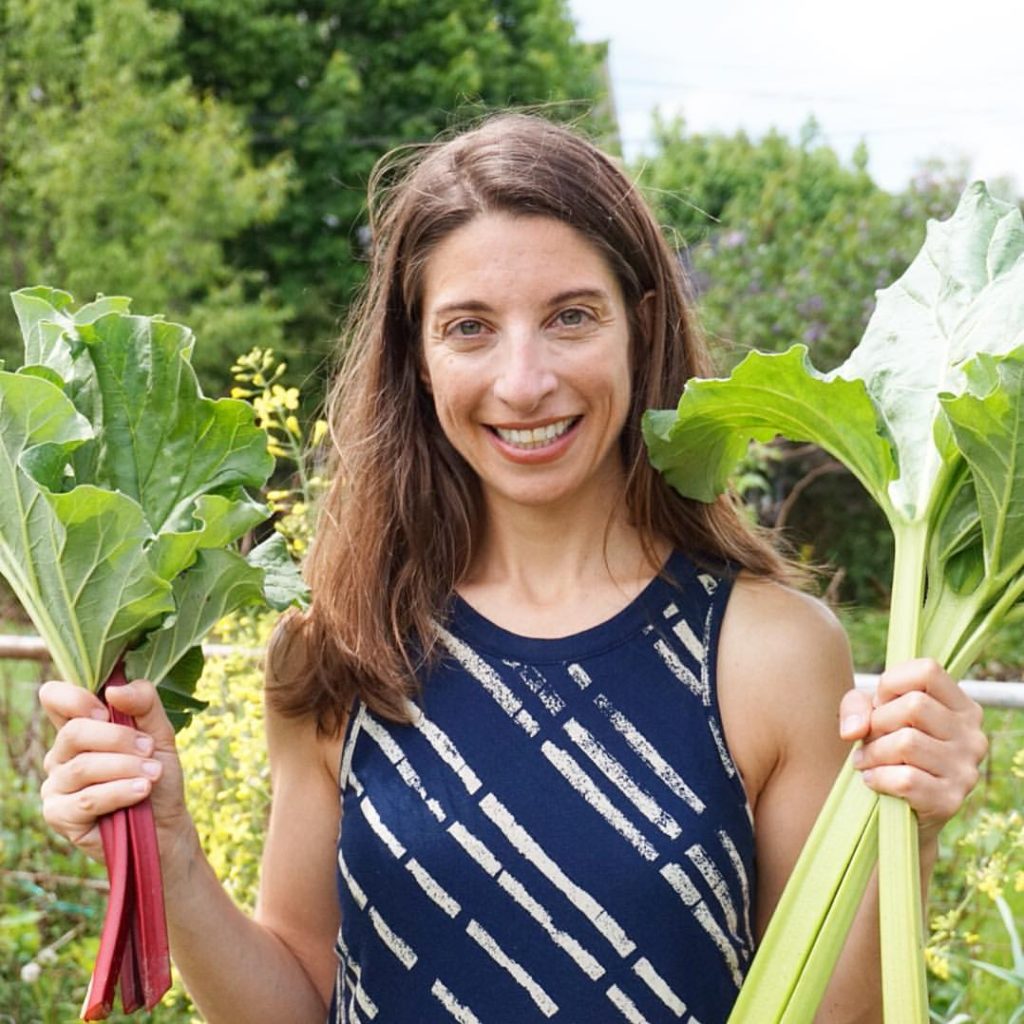 Emily with stalks of Rhubarb