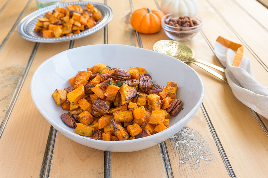 Roasted Sweet Potatoes with Apple Brandied Coconut Pecans in serving bowl