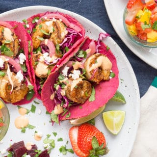 shrimp tacos in pink tortillas made with beet juice