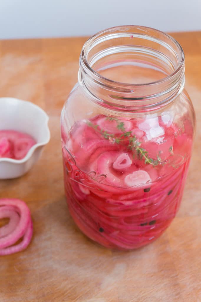 bright pink pickled red onion in jar