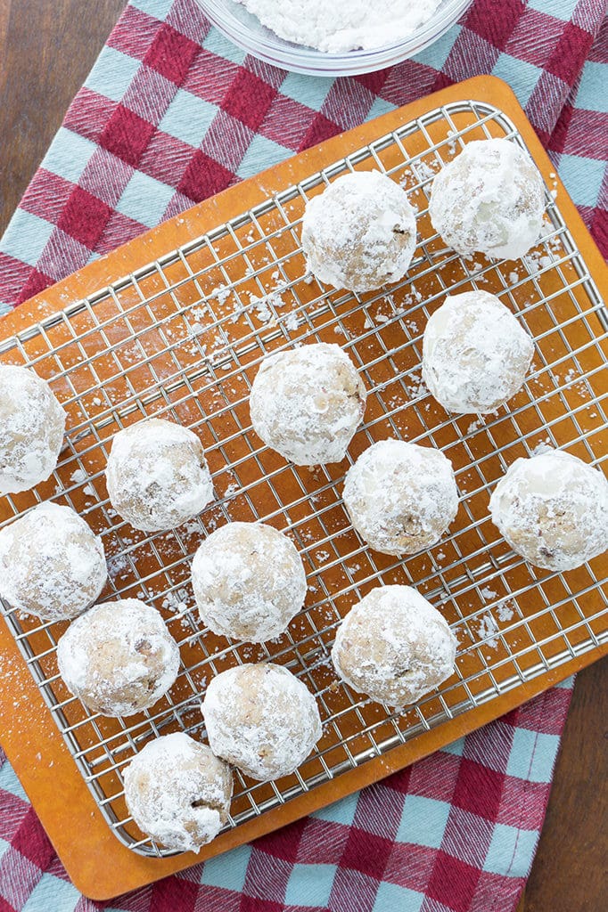 Maple Pecan Snowball Cookies on rack with powdered sugar