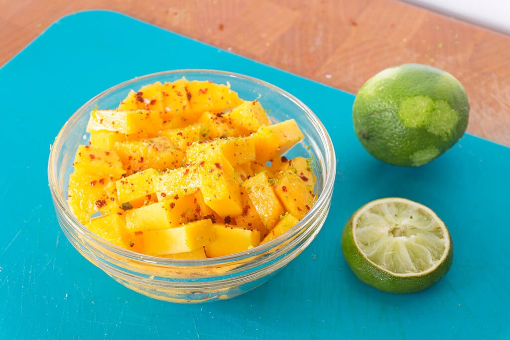 Mango with chili powder in bowl