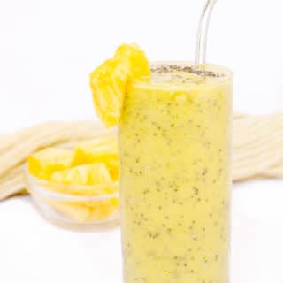 Pineapple Zucchini Smoothie in glass with stainless steel straw