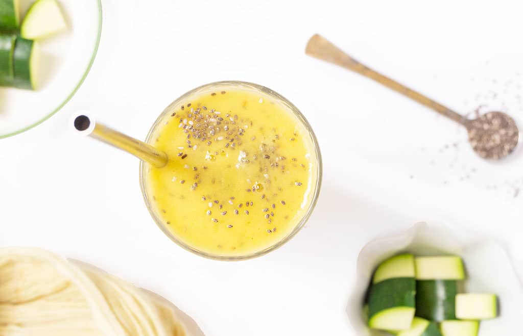 Pineapple Zucchini Smoothie 
 with chia seeds sprinkled on top overhead view