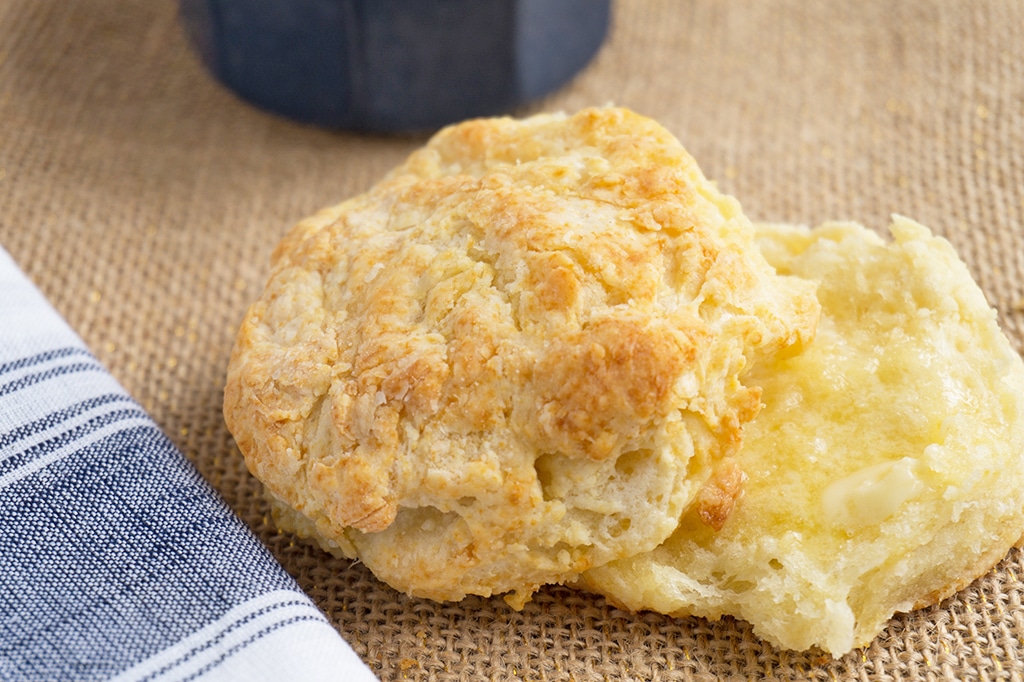 buttermilk biscuits cut in half with melted butter