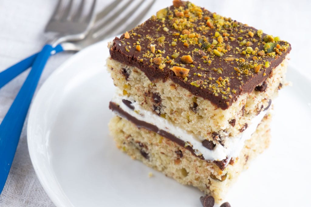 slice of cannoli cake with two blue forks