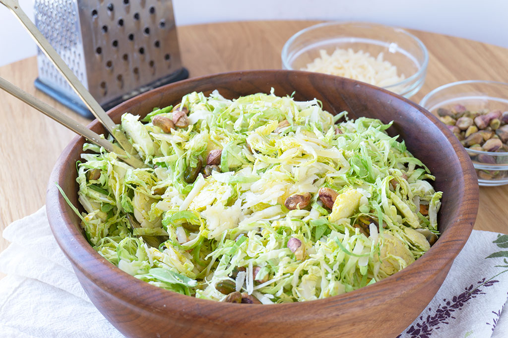 shredded brussels sprouts salad in a wooden bowl