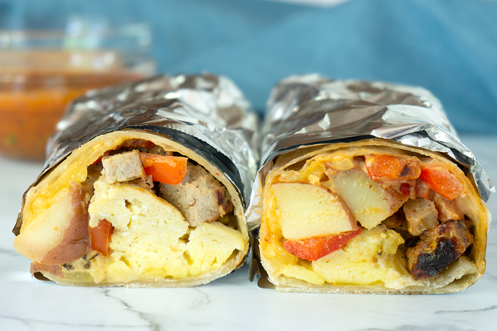 two breakfast burritos wrapped in foil