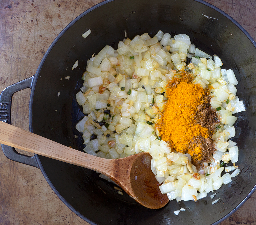 onions and spices in a stock pot