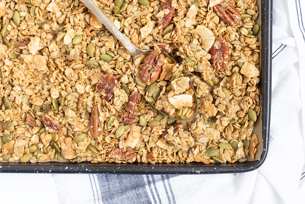 granola with pieces of pecans, blueberries, and greek yogurt